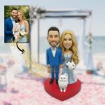 Bride and groom holding hands with a cat in front